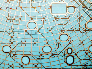 Circuit board made of plastic with circuit traces on blue background. The concept of technology, computing, electronics.