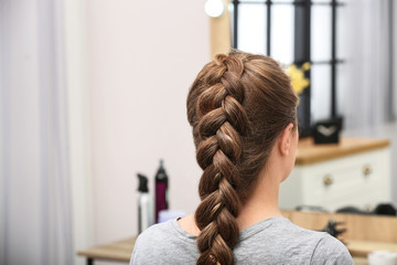 Woman with braided hair in professional salon