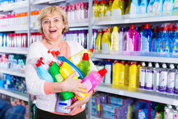 Woman consumer with household chemical products for washing indoors