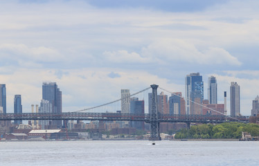 Manhattan bridge and skyline of New York City with skyscrapers background. View from Roosevelt Island