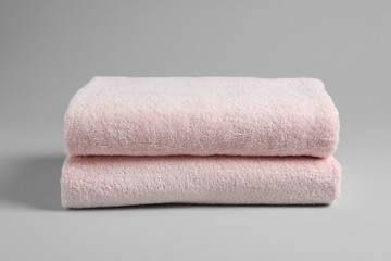 Fresh soft folded towels on light background