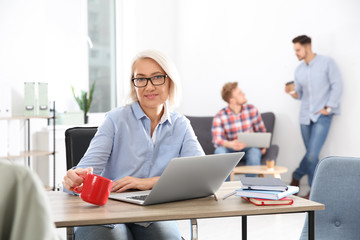 Obraz premium Businesswoman with colleagues working in office, space for text. Professional communication