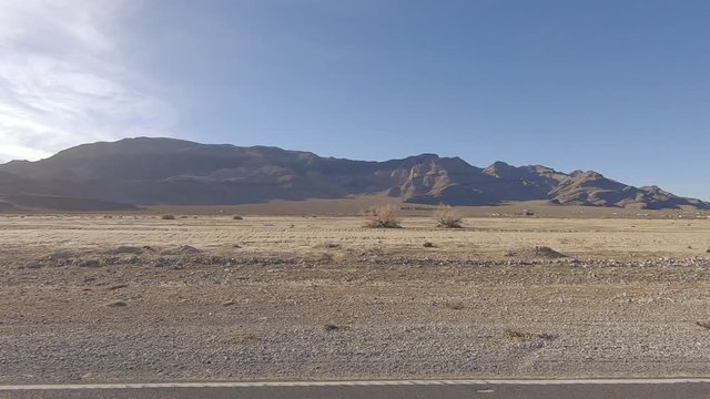 Driving North Leslie Rd in Pahrump Nevada passing Last Chance Range in the distance-Drive Plate-POV