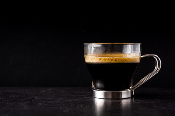 coffee glass and coffee grain on black background. Copyspace