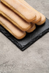 Italian Savoiardi ladyfingers Biscuits on concrete backgound