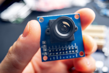 Camera with lens on electronic integrated circuit Board. Concept of high technology and robotics