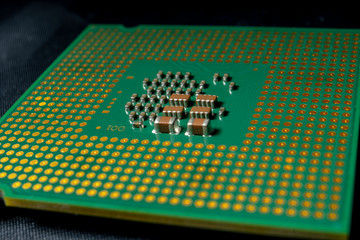 Green electronic chip CPU closeup. Concept of high technology and repair microchip