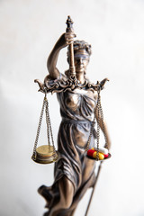statue of justice with pills and money balance