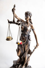 statue of justice with pills and money balance