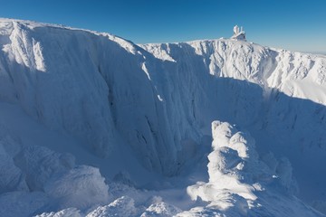 Snow Structure with sunshine in the Background, Panorama of Snow Holes With Wawel Transmitter - Krkonose (Giant Mountains), Czech Republic, Europe Sun shines over the winter czech mountains ski resort