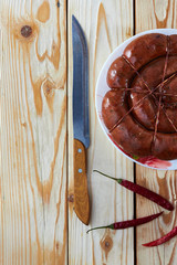 Lunch for the man on the table: smoked sausage, tomato - delicious food.