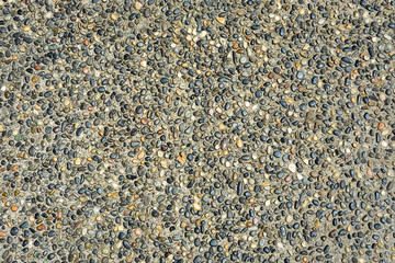 Small colored stones in concrete texture background