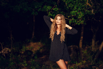 Happy pretty girl in field at sunset. Art photo