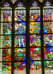 Joan of Arc war scene on colorful stained glass window inside the Cathedral of the Holy Cross in Orleans, France