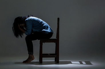 An Asian woman is suffering from depression.