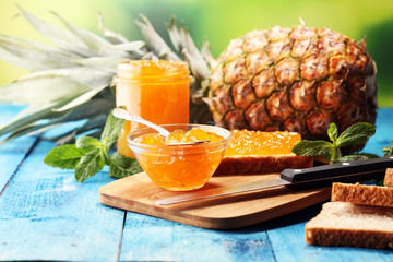 Toast bread with homemade pineapple jam or marmalade on table served with butter for breakfast or brunch