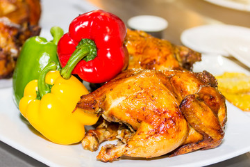 delicious roast chicken on white plate with colorful vegetable