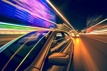Night car and speedy blured neon lights