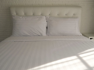 Fototapeta na wymiar Double bedroom with white pillows and blanket.