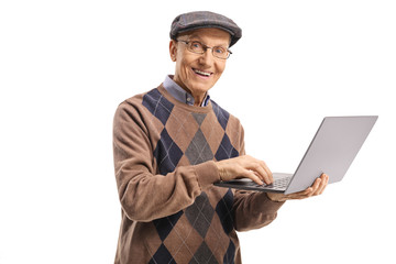 Smiling senior man holding a laptop computer and looking at the camera