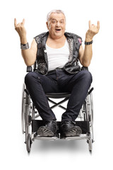 Crazy senior male punker in a wheelchair making a horn sign