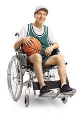 Fototapeta na wymiar Senior disabled man holding a basketball and sitting in a wheelchair