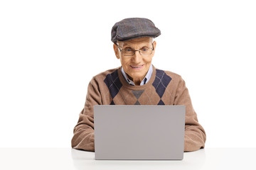 Senior man sitting and using a laptop
