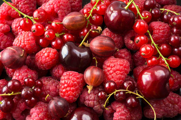 Background of raspberries, red currants and cherries. Fresh berries closeup. Top view. Background of red berries. Various fresh summer fruits. Red raspberries.