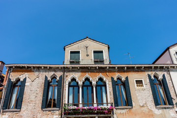 Obraz premium Italy, Venice, a stone church with a clock on the side of a building