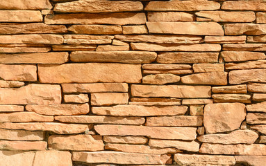 Sand colored stone setting. Stone wall texture