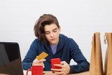 young man with credit card and laptop buying online