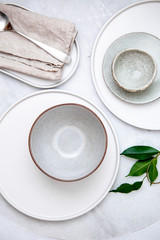 Empty plate and bowl on marble table. rustic style serving concept with copy space