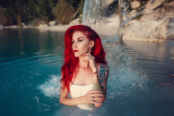 Cosplay on a mermaid Ariel, woman with red hair