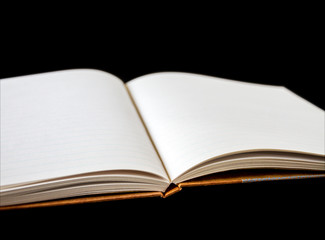 Open blank notebook on black background