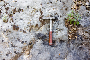 Geological hammer on the rock