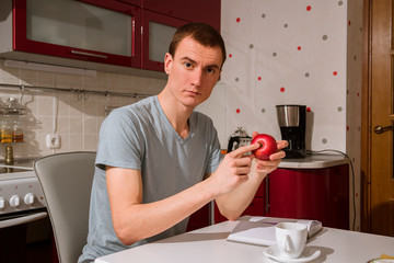 the guy is eating an apple