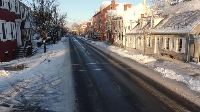 Snow covering downtown Lititz, aerial pull back, no people 4k