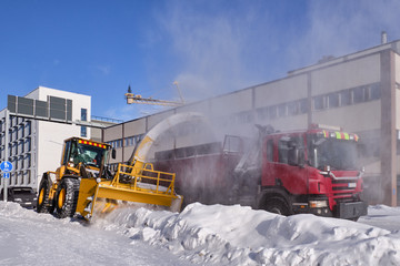 Snowplow removing snow in the street