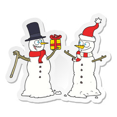 sticker of a cartoon snowmen exchanging gifts