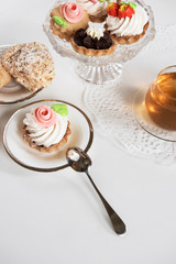 Cakes with tea on white background