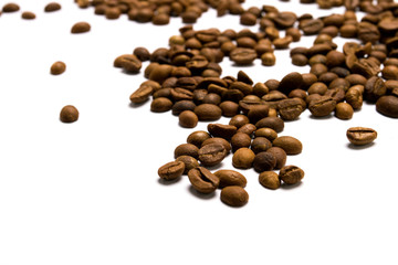 Grains of coffee scattered on a white isolated background