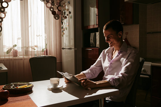 Guy having coffee in the morning kitchen