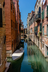 Fototapeta na wymiar Italy, Venice, Grand Canal, BOATS MOORED ON CANAL AMIDST BUILDINGS IN CITY AGAINST SKY