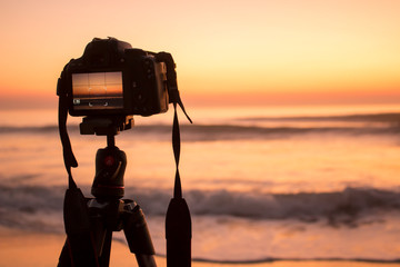 Camera on tripod during a sunset on the beach