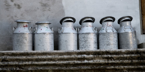 Naklejka premium Milk canisters arranged in row, Pecherek Village, West Sikkim, Sikkim, India