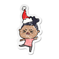 distressed sticker cartoon of a angry woman wearing santa hat