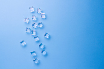 Cubes of ice on a light blue background. Flat lay, top view