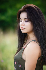 Naklejka premium young girl standing by the leaves
