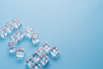 Word Ice lined with ice cubes on a light blue background