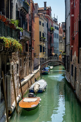 Italy, Venice, BOATS MOORED IN CANAL AMIDST BUILDINGS IN CITY